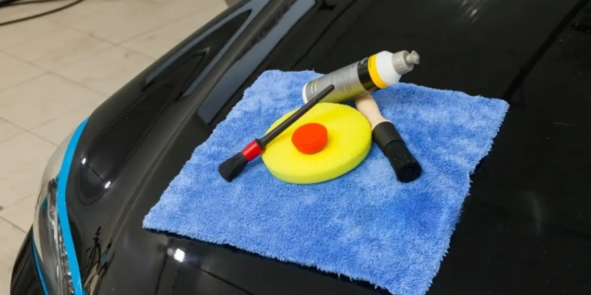 Drying a car with a microfiber towel after exterior detailing