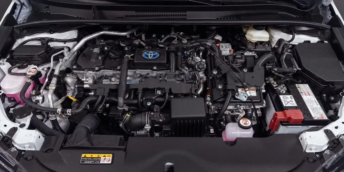 Inspecting a used Toyota Corolla engine bay for fluid leaks and wear