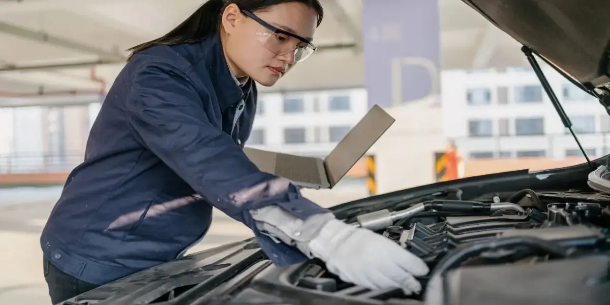Mechanic inspecting a used Toyota Corolla engine before purchase
