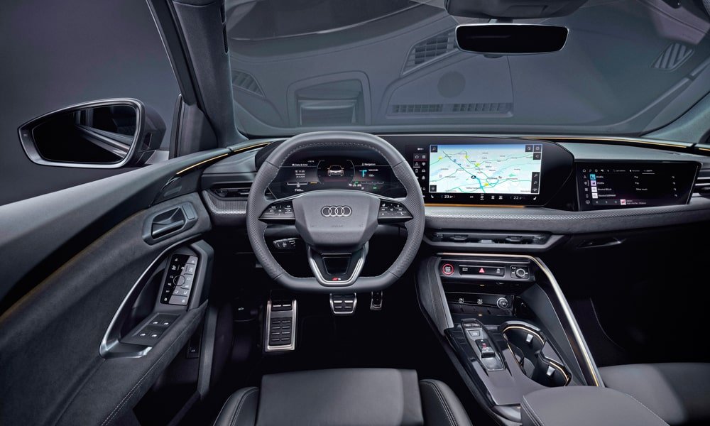 Interior dashboard and driver cockpit of an Audi Q5 featuring a multi-screen digital display and leather steering wheel.