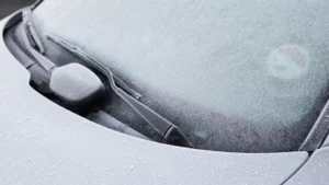 Car covered in heavy ice and frost on a cold winter morning