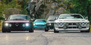 Classic restomod cars lined up on road showing modern LED lights