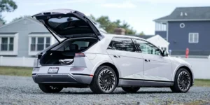 A sleek silver used Toyota Prius hybrid car driving on a scenic road representing top reliable used hybrid models in 2026.
