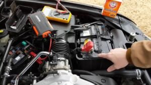 Driver inspecting engine bay during routine car maintenance check.