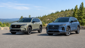 “Toyota RAV4 and Honda CR-V shown side by side on a scenic mountain road.”